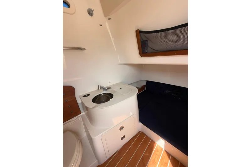 Slide: The Image of 2021 Grady-White Canyon 336 cabin interior with sink and bed. - 50