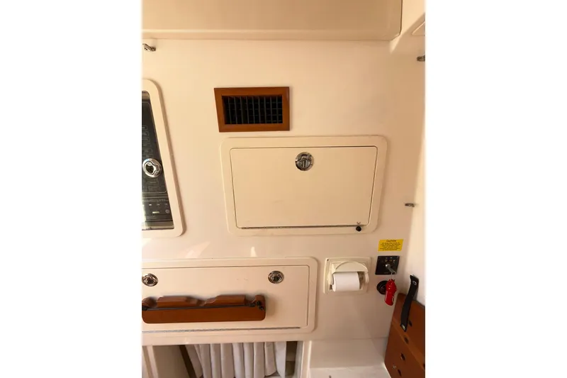 Slide: The Image of Interior view of a 2021 Grady-White Canyon 336 boat, featuring storage compartments. - 54