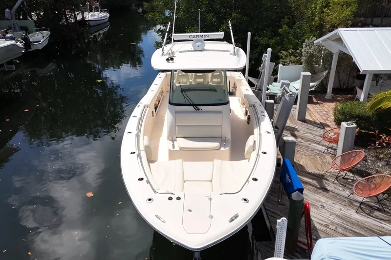 Slide: The Image of 2021 Grady-White Canyon 336 boat docked near a wooden deck. - 6