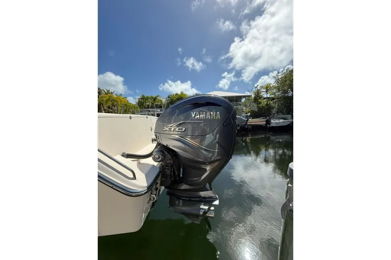 Slide: The Image of Yamaha XTO outboard motor on 2021 Grady-White Canyon 336 boat, docked by water. - 8