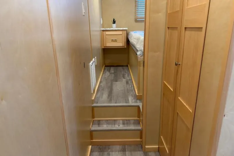 Slide: The Image of Interior of 2026 Sumerset Voyager with wooden steps, cabinets, and modern decor. - 10