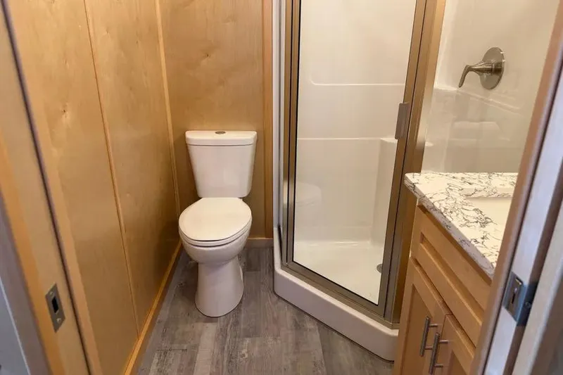 Slide: The Image of Compact bathroom in 2026 Sumerset Voyager with shower, toilet, and marble countertop. - 14