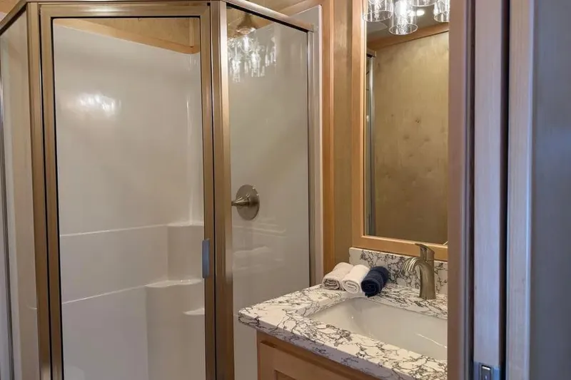 Slide: The Image of Luxurious bathroom in 2026 Sumerset Voyager with marble countertop and glass shower. - 15