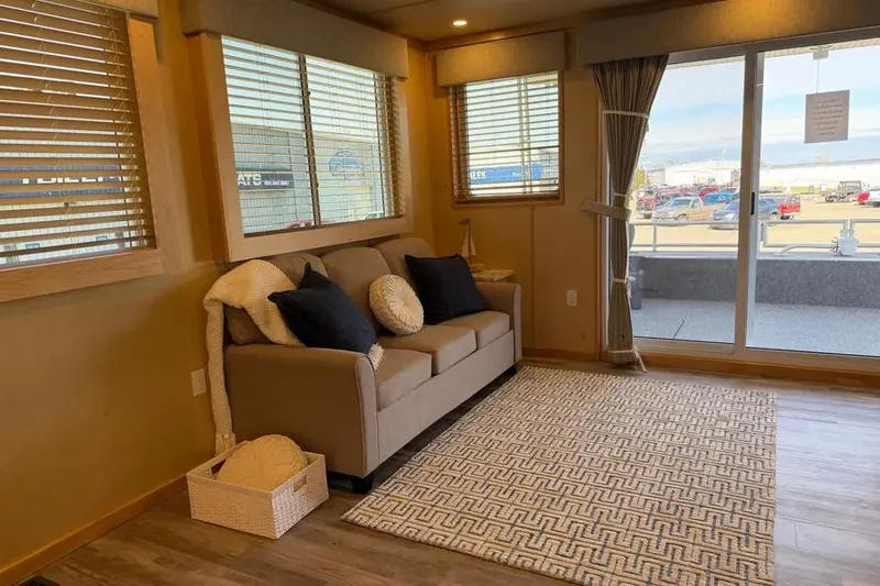 Slide: The Image of Modern living area in 2026 Sumerset Voyager houseboat with cozy sofa and large windows. - 6