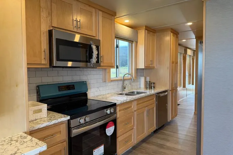 Slide: The Image of Modern kitchen interior in 2026 Sumerset Voyager houseboat with wooden cabinets and stainless steel appliances. - 7
