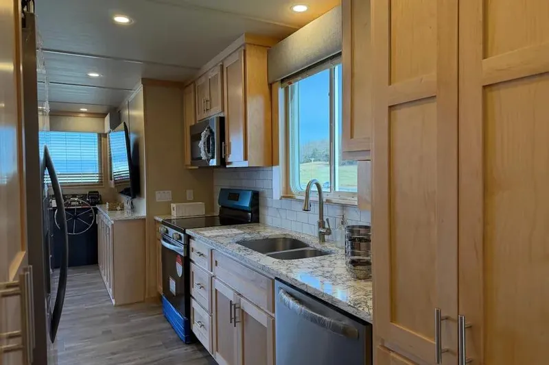 Slide: The Image of Modern kitchen interior in 2026 Sumerset Voyager houseboat with wooden cabinets and stainless steel appliances. - 9