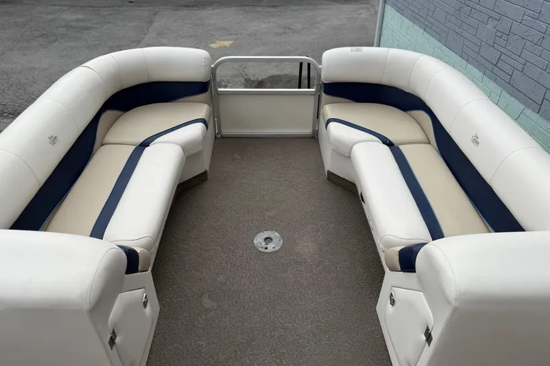 Slide: The Image of 2007 SunCatcher LX 22 SE pontoon boat interior with white and blue seating. - 7