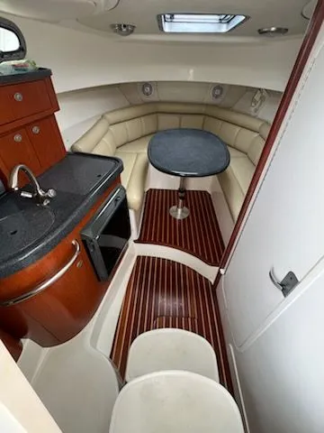 Slide: The Image of Interior of 2006 Boston Whaler 305 Conquest with kitchenette and seating area. - 10