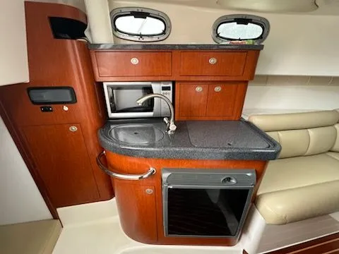 Slide: The Image of Interior of 2006 Boston Whaler 305 Conquest featuring kitchenette. - 9