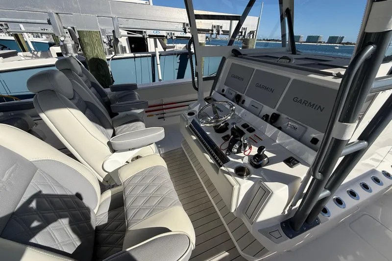 Slide: The Image of Luxurious helm of 2022 Invincible 40 Catamaran with advanced Garmin navigation systems. - 10
