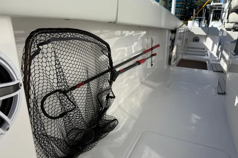 Slide: The Image of 2022 Invincible 40 Catamaran deck with fishing net and rods stored neatly. - 16
