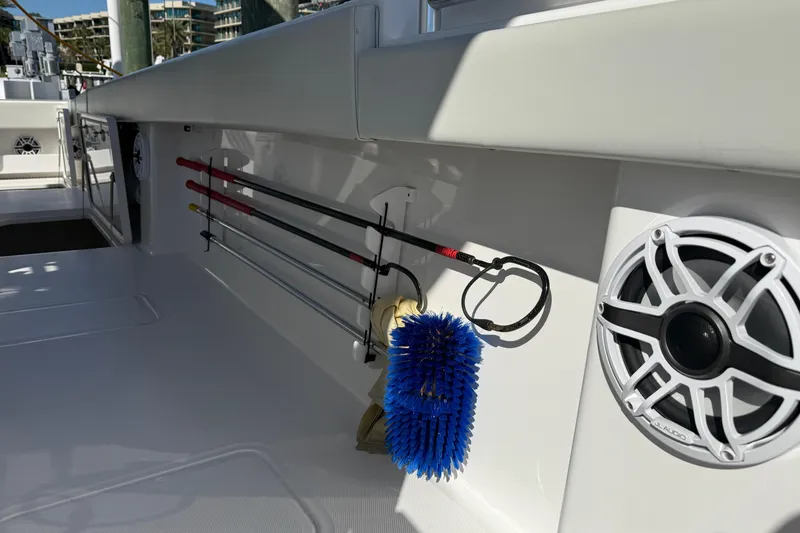Slide: The Image of 2022 Invincible 40 Catamaran deck with fishing rods, brush, and speaker. - 17