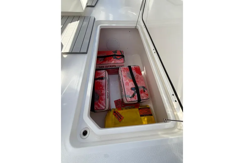 Slide: The Image of Storage compartment on 2022 Invincible 40 Catamaran with life jackets and safety equipment. - 18