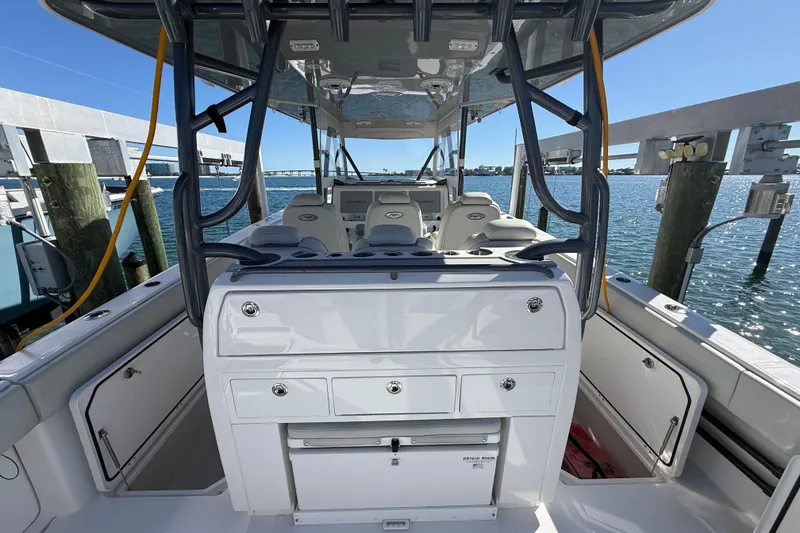 Slide: The Image of 2022 Invincible 40 Catamaran interior with seating and storage, docked by the water. - 20