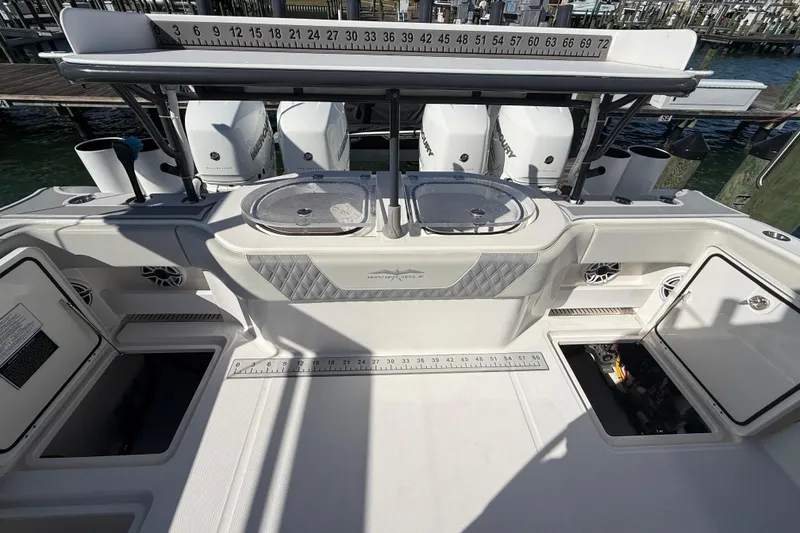 Slide: The Image of 2022 Invincible 40 Catamaran deck with storage compartments and fishing equipment. - 24