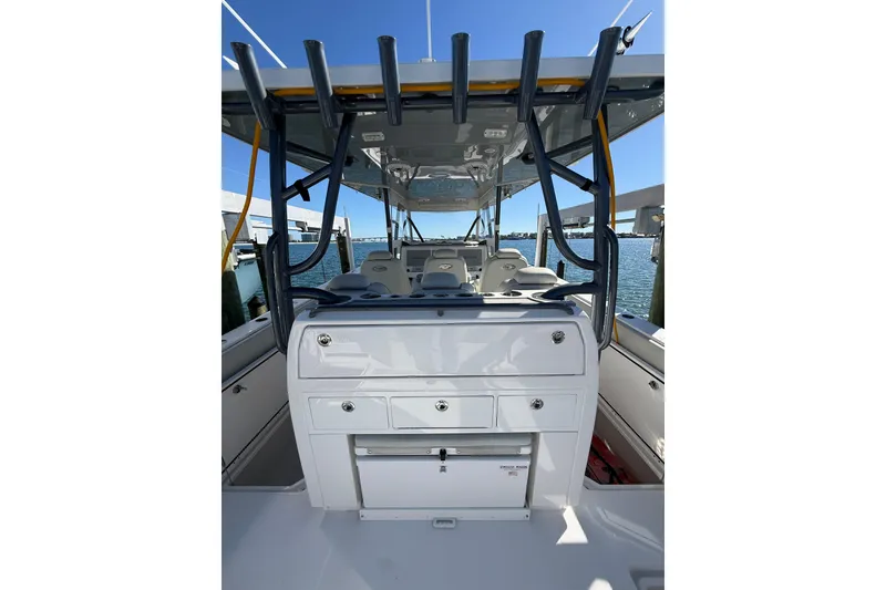 Slide: The Image of 2022 Invincible 40 Catamaran interior with seating and storage, docked by the water. - 25