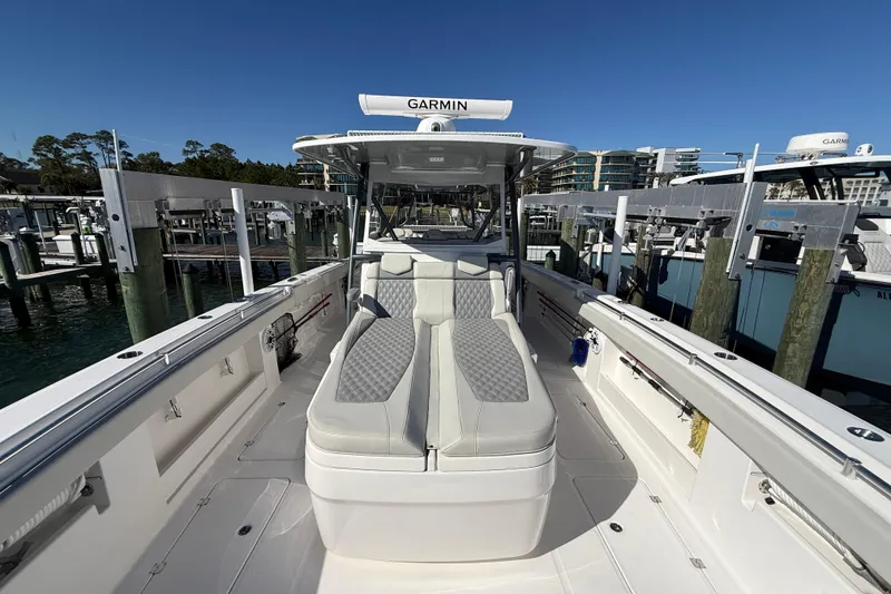 Slide: The Image of 2022 Invincible 40 Catamaran at dock, featuring spacious seating and Garmin equipment. - 4