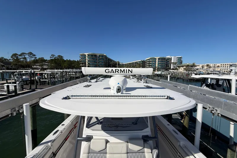 Slide: The Image of 2022 Invincible 40 Catamaran with Garmin equipment docked at a marina. - 6