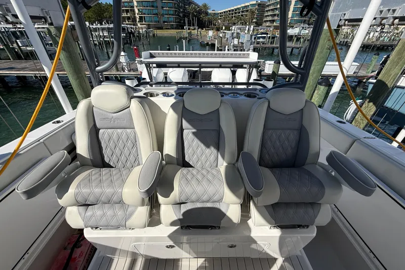 Slide: The Image of Luxurious seating on 2022 Invincible 40 Catamaran, featuring three plush, diamond-stitched chairs. - 9