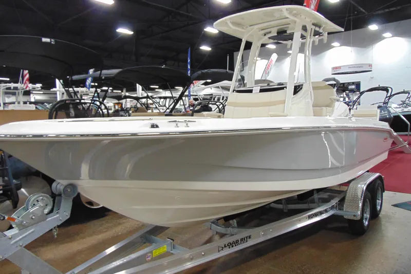 The Image of 2026 Boston Whaler 220 Dauntless boat displayed indoors on a trailer. - 12