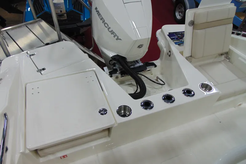 Slide: The Image of 2026 Boston Whaler 220 Dauntless boat with Mercury engine and seating area. - 15
