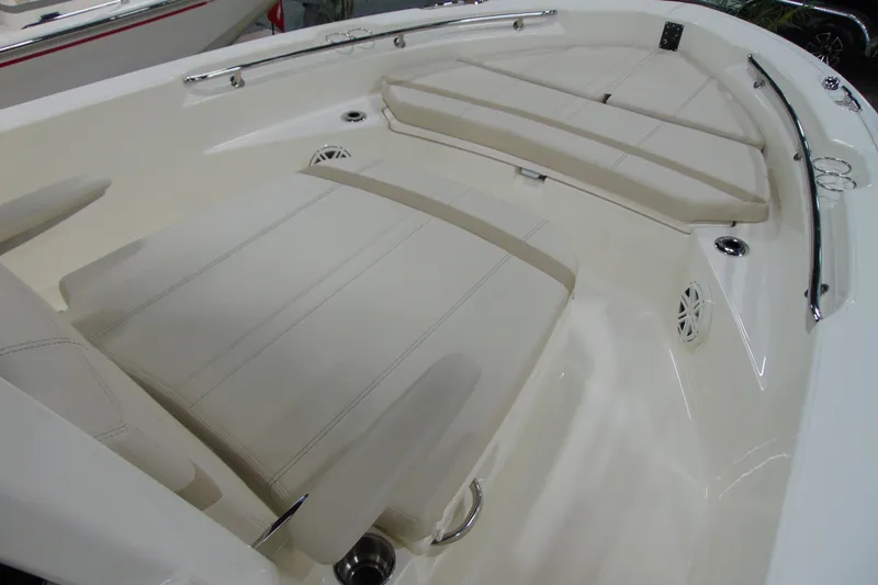 Slide: The Image of 2026 Boston Whaler 220 Dauntless boat interior with cushioned seating and stainless steel fixtures. - 20