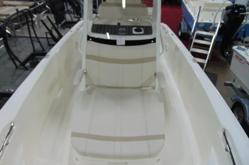 Slide: The Image of 2026 Boston Whaler 220 Dauntless interior view showcasing seating and console features. - 21