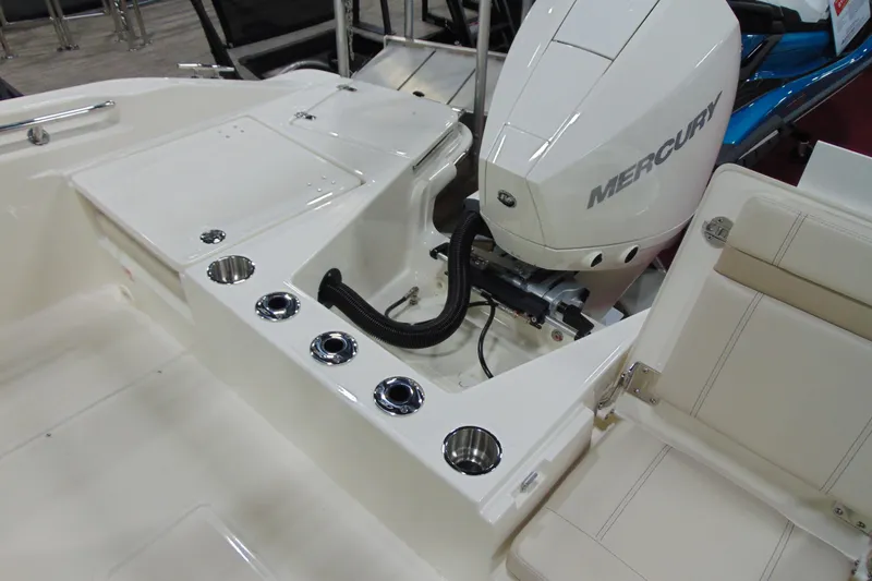 Slide: The Image of 2026 Boston Whaler 220 Dauntless boat with Mercury engine and seating area. - 24