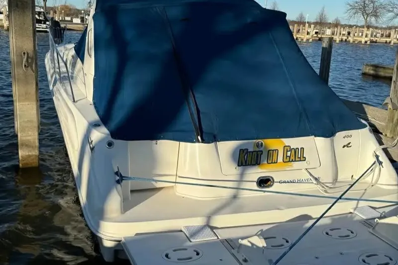 Slide: The Image of 1997 Sea Ray Sundancer 400 docked with blue cover, rear view. - 10