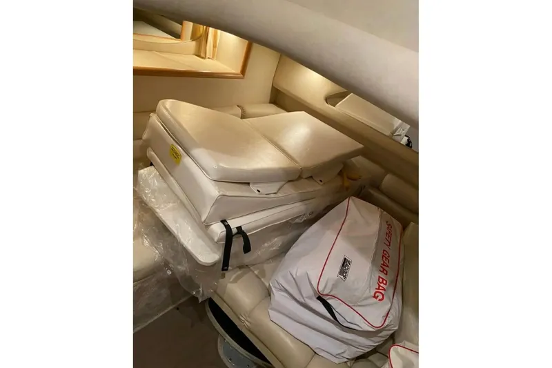 Slide: The Image of 1997 Sea Ray Sundancer 400 cabin interior with safety gear bag and cushions. - 11