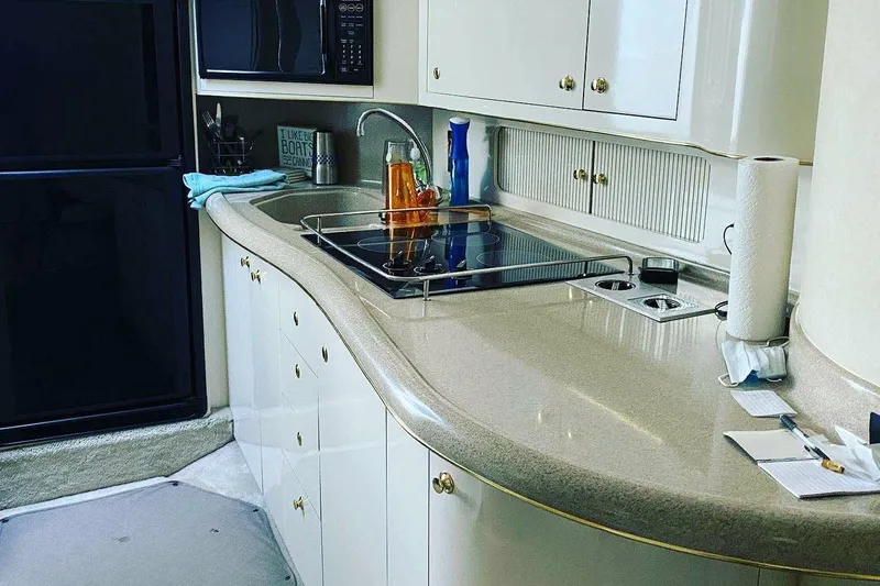 Slide: The Image of Luxurious kitchen interior of 1997 Sea Ray Sundancer 400 yacht with modern amenities. - 13
