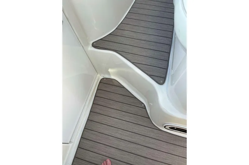 Slide: The Image of 1997 Sea Ray Sundancer 400 boat deck with textured flooring and white interior. - 15