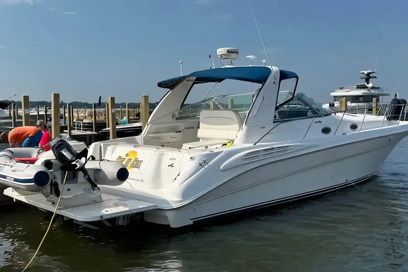 Slide: The Image of 1997 Sea Ray Sundancer 400 docked at marina with inflatable boat attached. - 5