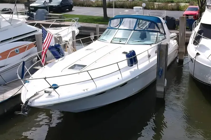Slide: The Image of 1997 Sea Ray Sundancer 400 docked, featuring sleek design and American flag. - 6
