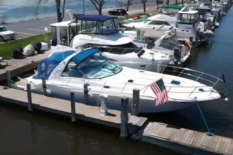 Slide: The Image of 1997 Sea Ray Sundancer 400 docked at marina with American flag. - 8