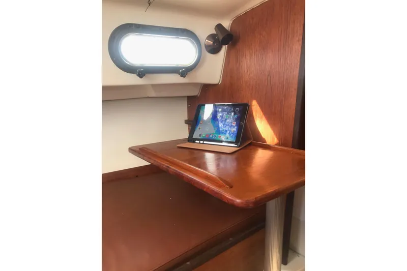 Slide: The Image of Interior cabin of a 1981 Cape Dory 25 sailboat with portholes and wooden accents. - 10