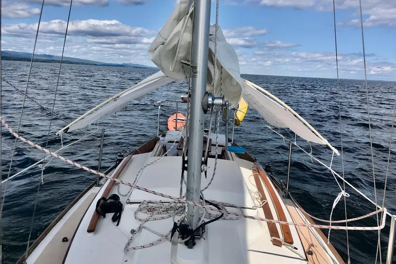 Slide: The Image of Wooden interior of 1981 Cape Dory 25 sailboat with hangers on a rod. - 13