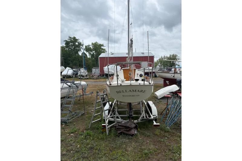 Slide: The Image of 1981 Cape Dory 25 sailboat on open water under a partly cloudy sky. - 16