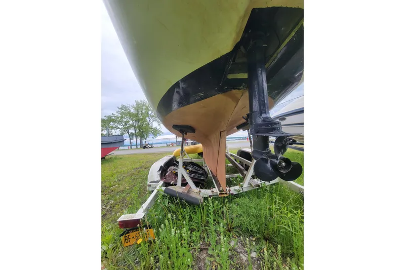 Slide: The Image of 1981 Cape Dory 25 sailboat "Bellamare" on land, overcast sky, boatyard setting. - 18