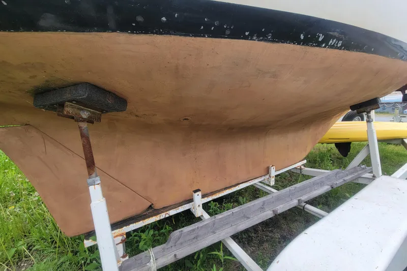 Slide: The Image of 1981 Cape Dory 25 sailboat on trailer, grassy area, overcast sky. - 19