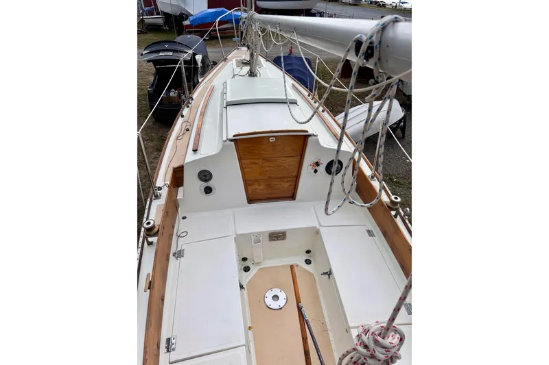 Slide: The Image of 1981 Cape Dory 25 sailboat on trailer, showing propeller and keel, parked on grass. - 20