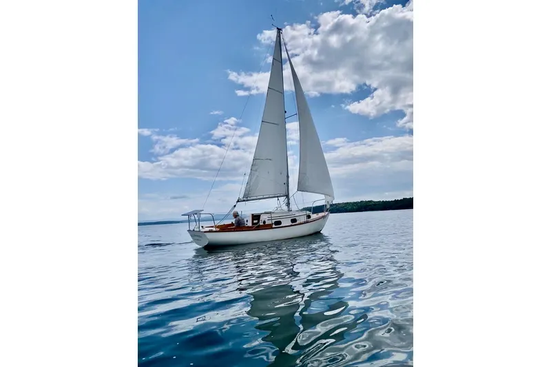 Slide: The Image of Sail of 1981 Cape Dory 25 yacht against a cloudy sky. - 5
