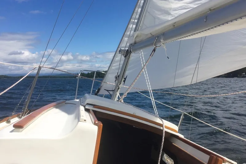 Slide: The Image of Interior of a 1981 Cape Dory 25 sailboat with wooden finishes and cozy seating. - 7