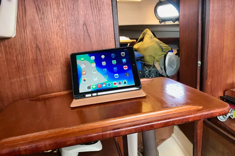 Slide: The Image of Interior of 1981 Cape Dory 25 sailboat with wooden table and tablet. - 9