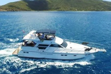 The Image of Luxury Horizon 56 yacht cruising in blue waters, 2001 model, with scenic island backdrop. - 0