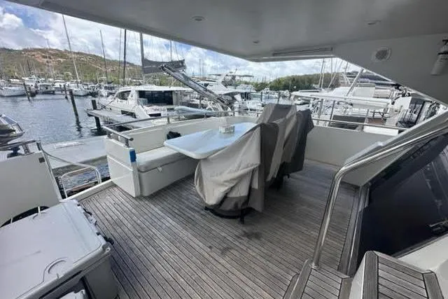 Slide: The Image of Covered deck area of a 2001 Horizon 56 yacht in a marina setting. - 17