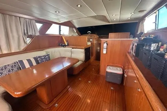 Slide: The Image of Luxurious 2001 Horizon 56 yacht interior with wooden furnishings and cozy seating area. - 18