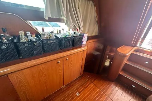 Slide: The Image of Luxurious 2001 Horizon 56 yacht interior with wooden cabinetry and beverage storage baskets. - 20