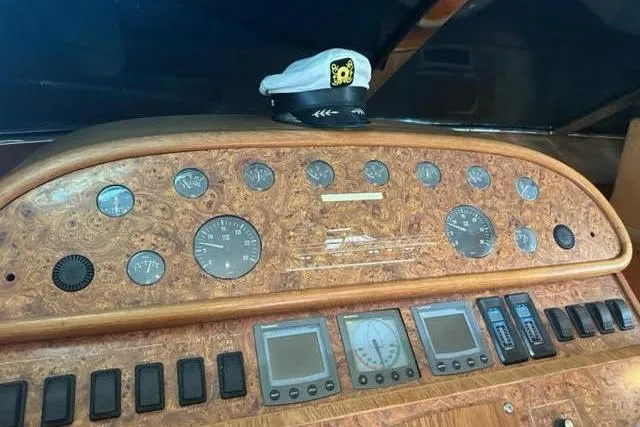 Slide: The Image of Control panel of a 2001 Horizon 56 yacht with captain's hat on top. - 24