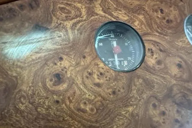 Slide: The Image of Wooden dashboard with a round gauge from a 2001 Horizon 56 vehicle. - 25